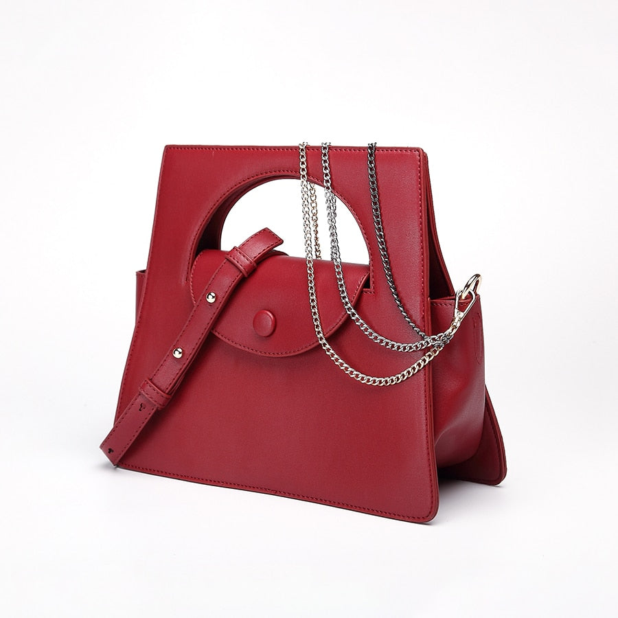 Bolso tote geométrico con cadena y detalle clutch